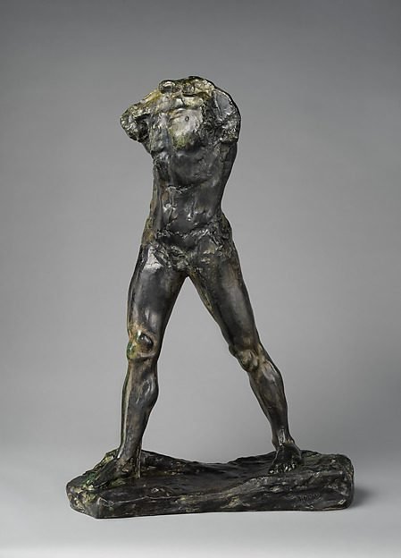 Auguste Rodin's The Walking Man, a headless, armless bronze with a green and brown patina